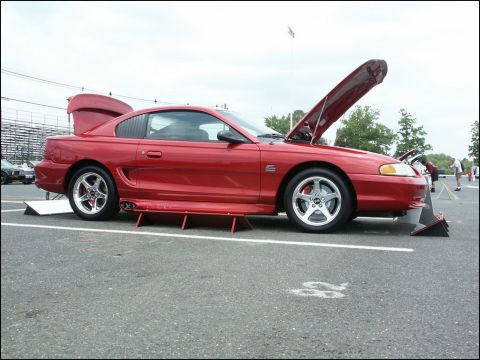 2001 Mercury Grand Marquis - A red coupe is displayed with its hood and trunk open at an outdoor car show.