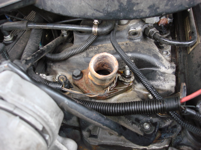 reinstall the stud and the bolt and then the ground wire and then the nut. the thermastat swap is complete.