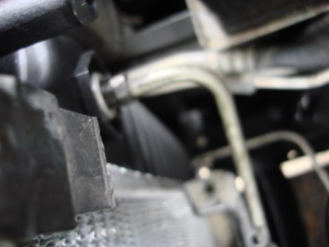 1983 Ford Bronco - after making sure the raditor was seated in the lower mounts i connected the tranny cooler lines.