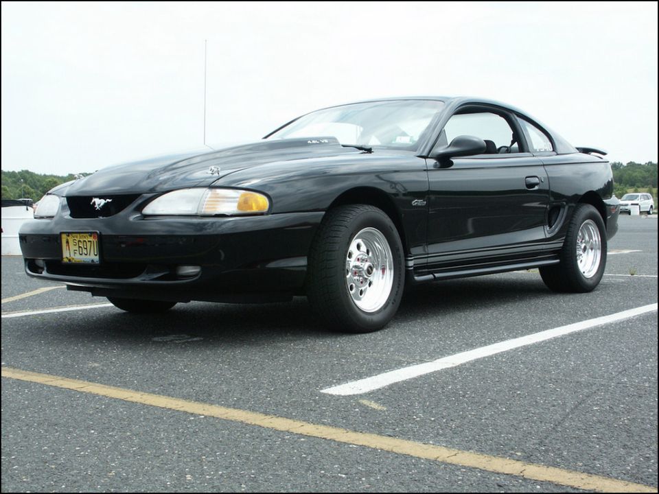 Black 1996 Ford Mustang coupe with racing slicks and hood scoop