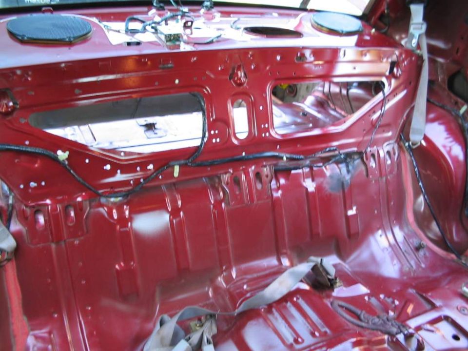 Stripped red rear interior body shell with speaker holes
