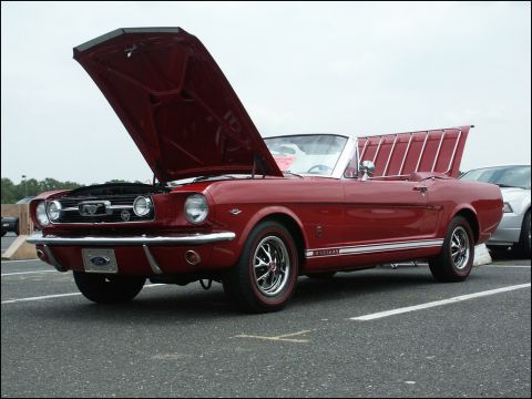 2001 Mercury Grand Marquis - A classic red 1965 Ford Mustang convertible is displayed with its hood and trunk open.