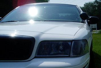 2000 Ford Crown Victoria - Front view of a 2000 Ford Crown Victoria, focusing on the headlights and grille area.