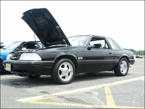 2001 Mercury Grand Marquis - Black Fox body Mustang coupe with hood open at a car show.