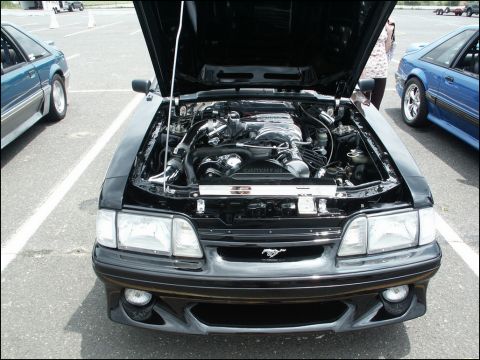 2001 Mercury Grand Marquis - A black car is displayed with its hood open, the engine compartment. Other vehicles are present in the background.