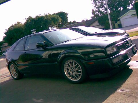 1993 Volkswagen Corrado - This black 1993 Volkswagen Corrado is captured in a three-quarter front view, parked alongside another vehicle.