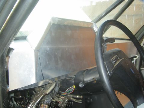 1990 Ford Bronco - Close view of a fabricated aluminum dashboard section next to a Ford steering wheel above exposed wiring.