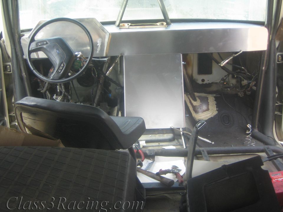 Stripped vehicle interior with aluminum dash, steering wheel and bucket seats