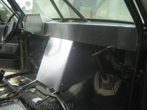 1990 Ford Bronco - Bare aluminum dash and center console structure inside a gutted vehicle cabin with exposed body and wiring.