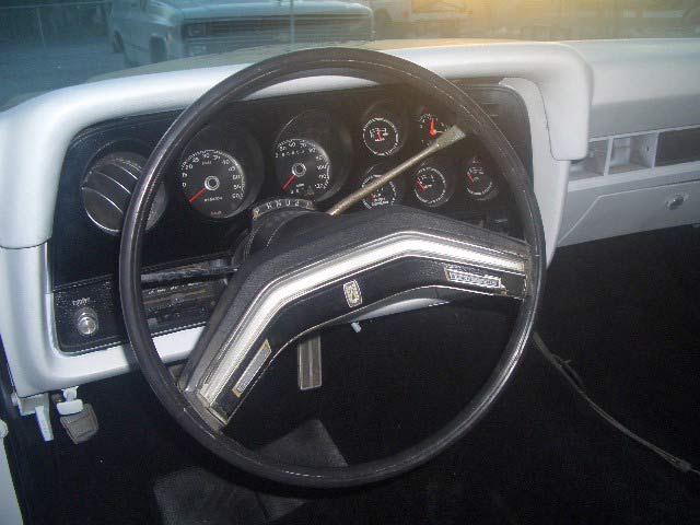 Vintage Ford steering wheel and instrument cluster with multiple round gauges