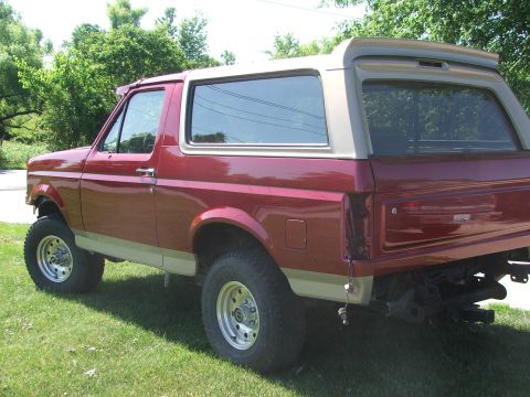 1994 Ford Bronco - This 1994 Ford Bronco is shown from the rear three-quarter angle, highlighting its two-tone paint scheme.