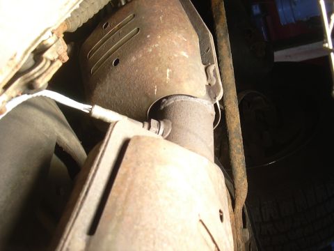 1996 Ford Crown Victoria - Underside view of a vehicle's exhaust system, focusing on the catalytic converter.