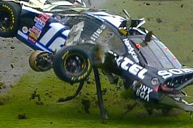 1981 Ford Bronco - A stock car is shown overturned on a grassy area, with debris scattered around the scene.