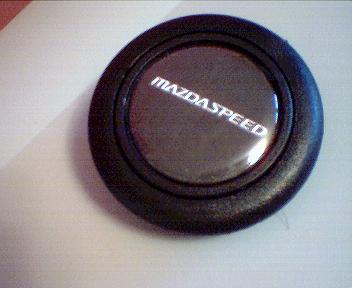 1993 Ford Probe - Close-up of a Mazdaspeed horn button, likely a replacement part.