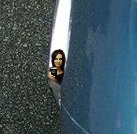 1971 Ford Ranchero - A woman with a cup is visible in a narrow opening between two surfaces.