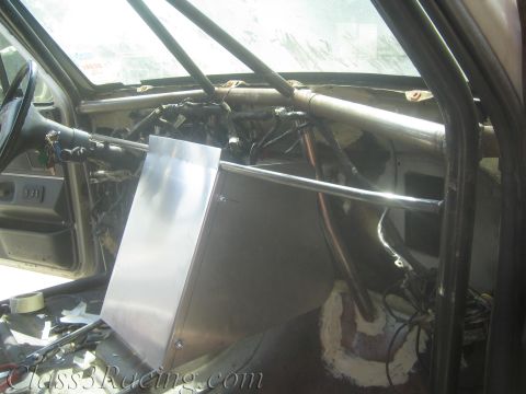 1990 Ford Bronco - fabricated aluminum dash box fitted against roll-cage tubing inside a gutted vehicle cabin.