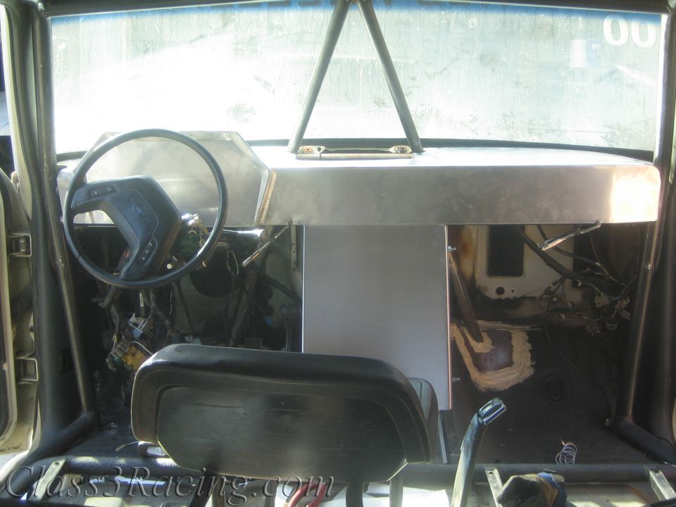 Stripped interior with aluminum dash, steering wheel and bench seat
