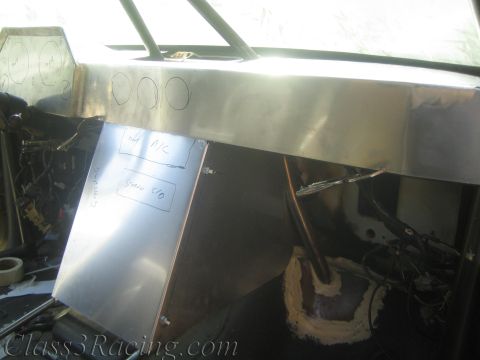 1990 Ford Bronco - fabricated aluminum dashboard panel marked with handwritten gauge labels sits in a stripped off-road race vehicle interior.