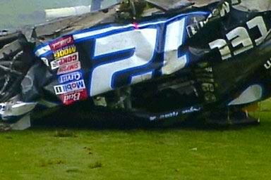 1981 Ford Bronco - A heavily damaged race car, identified by the number 21 and numerous sponsor decals, sits on the grass after an apparent crash.