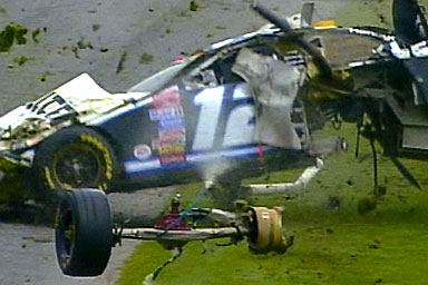 1981 Ford Bronco - A severely damaged race car lies on the grass after an apparent crash.
