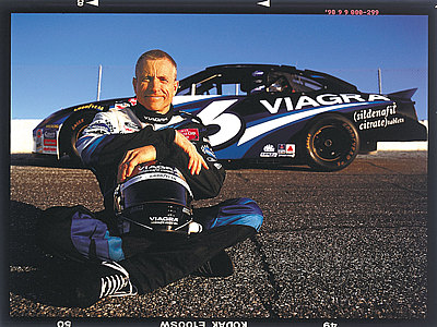 1981 Ford Bronco - A race car driver poses with his car, which features prominent Viagra sponsorship.