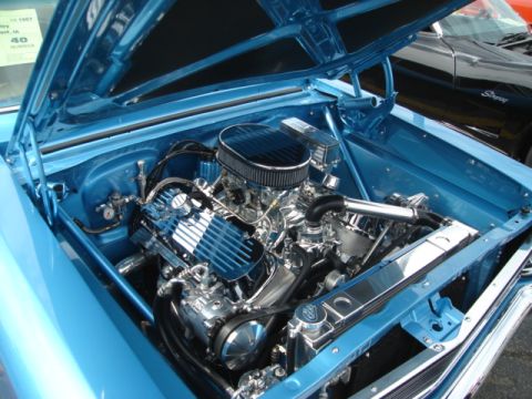 1992 Ford Crown Victoria - Close-up of a polished V8 engine in a classic car's engine bay, with a second vehicle in the background.