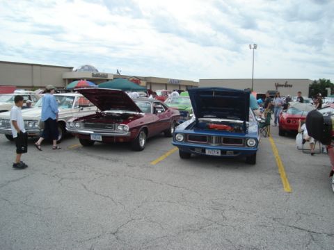 1992 Ford Crown Victoria - Outdoor car show various classic automobiles on a cloudy day.