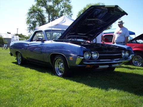 1972 Ford Ranchero - A blue 1970 Ford Falcon Ranchero is displayed with its hood open at an outdoor event, with another vehicle visible in the background.