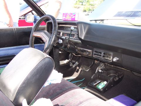 1972 Ford Ranchero - The interior of a classic car is shown, a dashboard with a radio and air vents.
