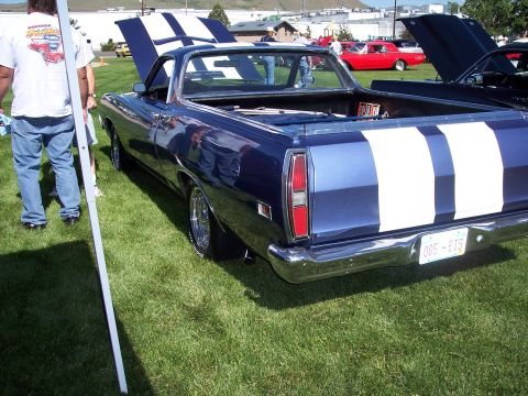 1972 Ford Ranchero - A blue Ford Ranchero with racing stripes is displayed at an outdoor event, with other vehicles nearby.