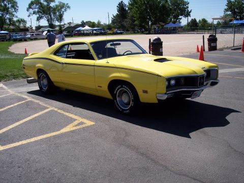 1972 Ford Ranchero - This yellow 1970 Mercury Cougar XR7 features distinctive black racing stripes and a prominent hood scoop.