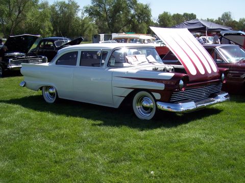 1972 Ford Ranchero - A two-tone 1956 Ford Fairlane Crown Victoria with its hood open at a car show.