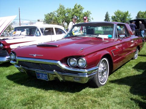 1972 Ford Ranchero - A classic maroon Ford Thunderbird is displayed at an outdoor event, with another vehicle visible to its left.