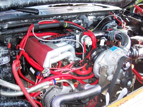 1972 Ford Ranchero - The engine bay is filled with custom red hoses and a prominent supercharger unit.