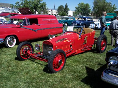 1972 Ford Ranchero - A vintage red racing car with the number 1 and 'Mellin' lettering is displayed at an outdoor event.