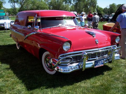 1972 Ford Ranchero - A bright red 1956 Ford sedan delivery van is displayed on a grassy field with people in the background.
