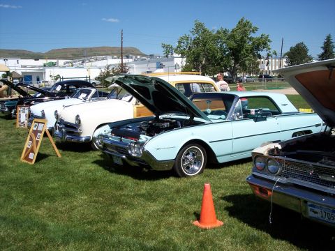 1972 Ford Ranchero - A light blue 1960 Ford Thunderbird convertible is displayed with its hood open at an outdoor event.