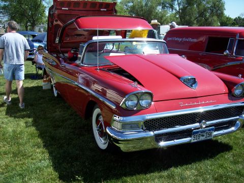 1972 Ford Ranchero - Red convertible with hood and trunk open, parked on grass at an outdoor event.