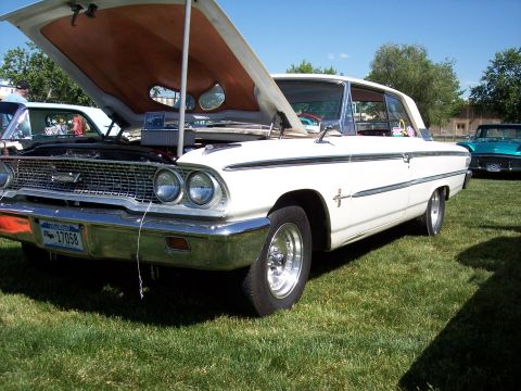 1972 Ford Ranchero - A classic white Ford Galaxie is displayed with its hood up at an outdoor event.