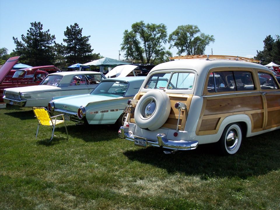 Woodie station wagon, white and wood paneling, spare tire on rear door, chrome bumper, whitewall tires