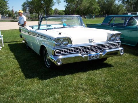 1972 Ford Ranchero - White 1959 Ford Fairlane 500 Skyliner convertible at a car show, with another vehicle visible to the right.