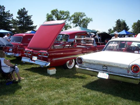 1972 Ford Ranchero - A red 1959 Ford Fairlane convertible is parked on grass with its trunk open.
