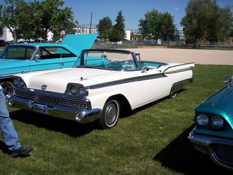 1972 Ford Ranchero - A white 1959 convertible with a turquoise interior is parked on grass next to other classic cars.