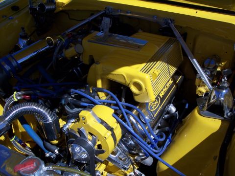 1972 Ford Ranchero - Close-up of a yellow Ford Racing engine bay, showing various components and wiring.