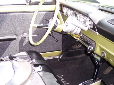 1972 Ford Ranchero - The interior features aftermarket gauges and a floor shifter, with "Comet" embroidered on the floor mat.