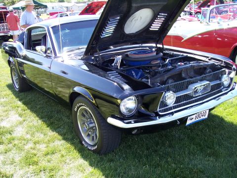 1972 Ford Ranchero - A black 1967 Ford Mustang is displayed with its hood open, revealing the engine and a prominent grille emblem.
