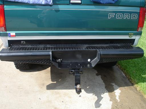 Green 1996 Ford F-150 rear with black diamond plate bumper and Texas flag sticker