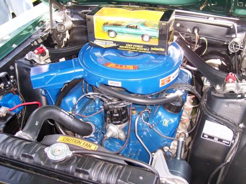 1972 Ford Ranchero - A toy 1969 Ford Mustang Mach 1 sits atop the engine's air cleaner in this close-up view.