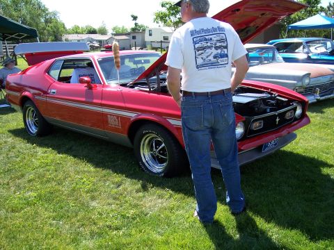1972 Ford Ranchero - A red 1971 Ford Mustang Mach 1 is displayed at an outdoor car show with its hood open.