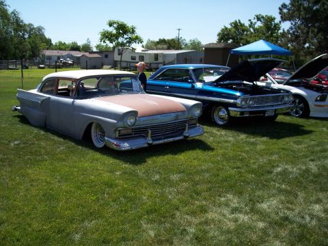 1972 Ford Ranchero - A classic 1957 Ford Fairlane 500 is displayed on a grassy field next to other vehicles.